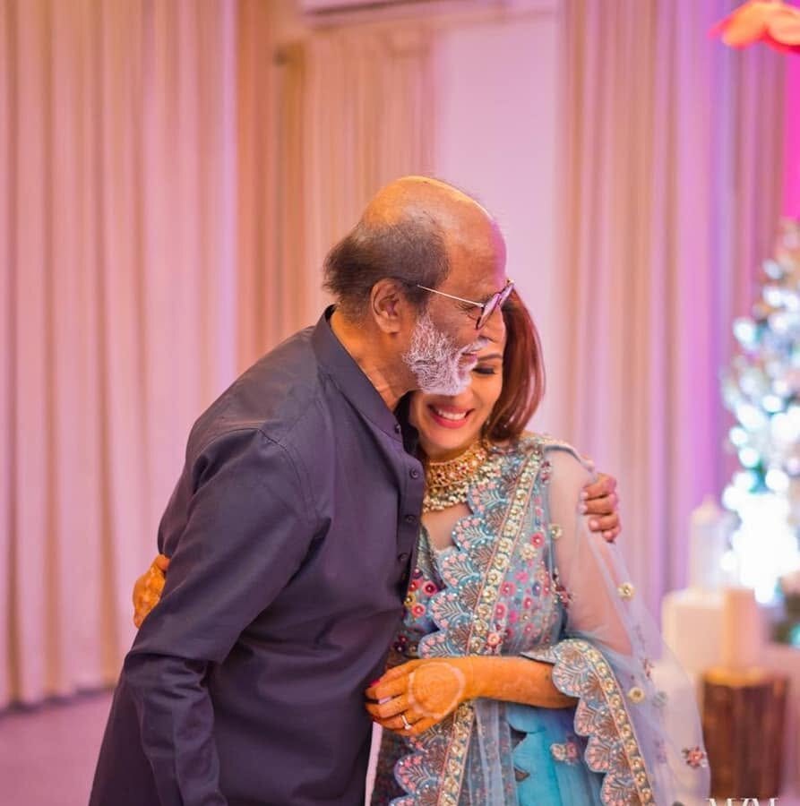 Soundarya Rajinikanth embraced by her father, the actor Rajinikanth, at a family celebration
