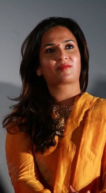 Soundarya Rajinikanth in a marigold-yellow outfit with gold jewellery at a promotional event
