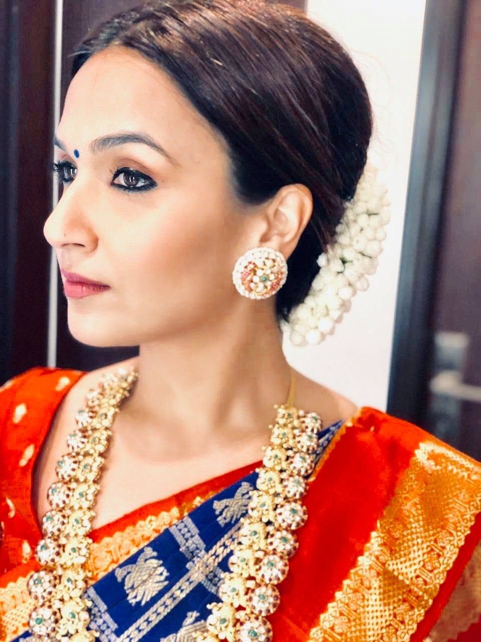 Profile portrait of Soundarya Rajinikanth wearing jasmine flowers and traditional jewellery