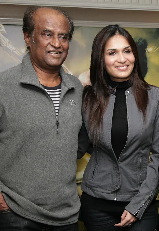 Soundarya Rajinikanth in a grey jacket beside her father Rajinikanth at a Kochadaiiyaan promotional event